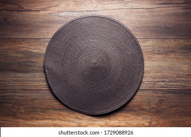 Brown Wicker Food Service Mat On Wooden Table. Overhead View.