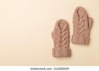 Brown Winter Mittens On Wooden Background. Top View.