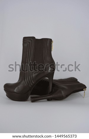 Brown women's stylish autumn boots made of genuine leather with high and thin heels.