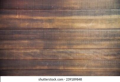 Brown wood floor texture background. plank pattern surface pastel painted wall; gray board grain tabletop above oak timber; tree desk,panel wooden dirty and cracked craft material dry sepia vintage.