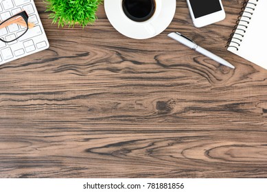 Brown Wood Office Desk Table And Equipment For Working And Listening Music With White Headphone In Top View And Copy Space.