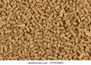 Brown wood pellets texture background. natural pile of wood pellets. organic biofuels. Alternative biofuel from sawdust. The cat litter. Close up on a pile of compressed wood pellets.  mulch