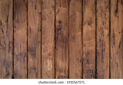 Brown wood texture background coming from natural tree. The wooden panel has a beautiful dark pattern, hardwood floor texture