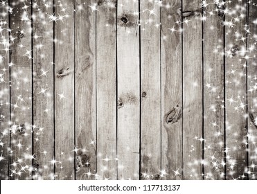 the brown wood texture with white snow and stars. Christmas background