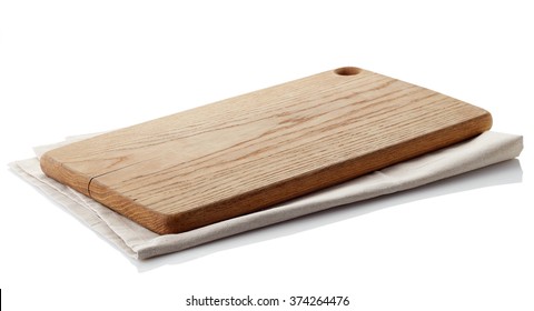 Brown wooden cutting board on cotton napkin isolated on white background. Clipping path