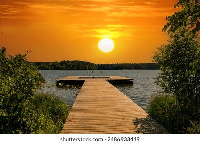 a brown wooden dock over the rippling blue waters of Lake Acworth surrounded by lush green trees and blue with powerful clouds at sunset at Cauble Park in Acworth Georgia USA - Powered by Shutterstock