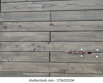 Brown Wooden Door Made Of Planks With A Copper Doorknob.