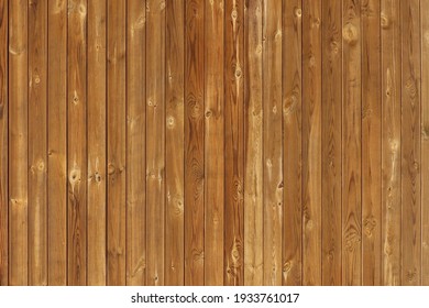 Brown wooden fence for abstract backgrounds and textures. Vertical wall varnished panels with knots. Slightly aged timber with some scratches. Reddish, walnut, ocker, tawny, warm shades wood linings. - Shutterstock ID 1933761017
