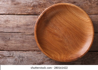 The brown wooden plate on a rustic table closeup. horizontal top view 