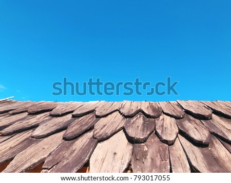 Brown wooden roof and blue sky with copy space for text design for background/wallpaper/card/template