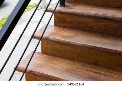 Brown Wooden Staircase With Iron Banister In Modern House