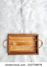 A Brown Wooden Tray With Rope Handle