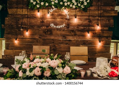 brown wooden wall at the table in the banquet hall for a wedding celebration with a monogram for the names on it