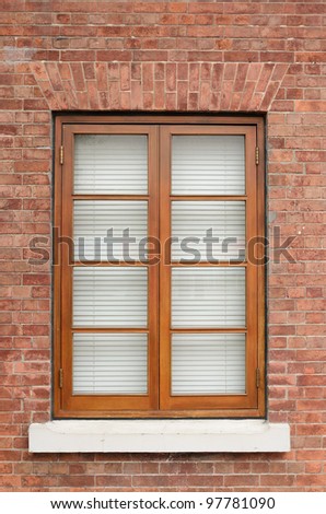 Brown wooden window on brick wall