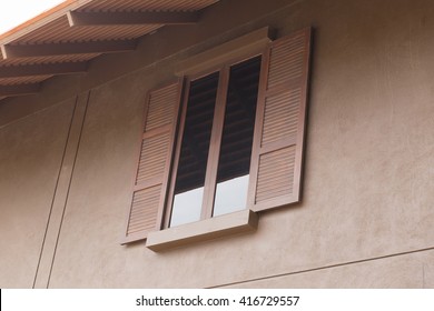 Brown Wooden Window With Tinted Glass