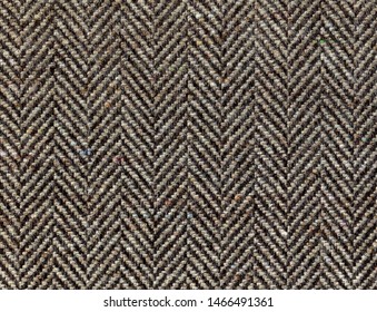 Brown Woolen Fabric Striped Zigzag. Herringbone Tweed, Wool Background Texture. Coat Close-up. Expensive Men's Suit Fabric. High Resolution