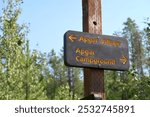 Brown and yellow arrow sign for Apgar village and Apgar campground at Glacier National Park. Find your way.