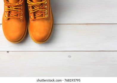 brown or yellow boots shoes for foot and adventure travel place on vintage white floor or table with copy space - Shutterstock ID 768193795