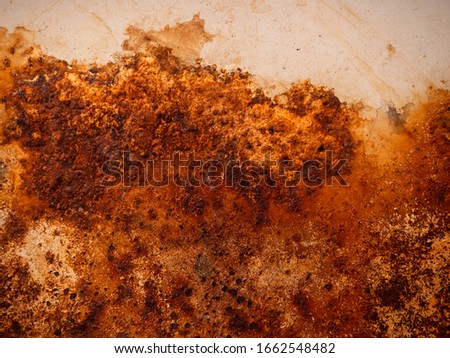 Brown and yellow rust on white enamel. Rusted brown and white abstract texture. Corroded white metal background. Rusted white painted metal wall. Rusty metal surface with streaks of rust.