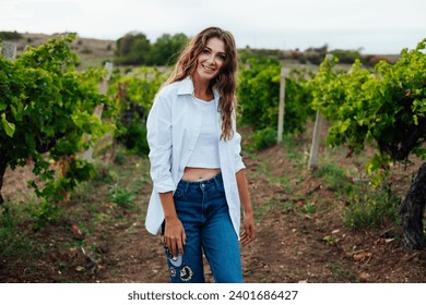 brown-haired woman in a vineyard at sunset - Powered by Shutterstock