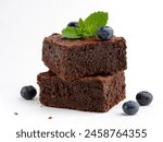 Brownie bars decorated with fresh blueberries and green mint leaf. Soft and moist chocolate fudge or chocolate cake on white background. Delicious sweets or dessert. Closeup food.