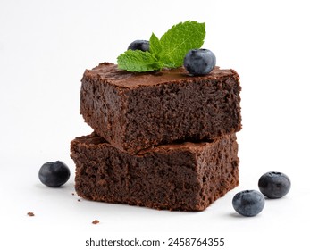 Brownie bars decorated with fresh blueberries and green mint leaf. Soft and moist chocolate fudge or chocolate cake on white background. Delicious sweets or dessert. Closeup food. - Powered by Shutterstock