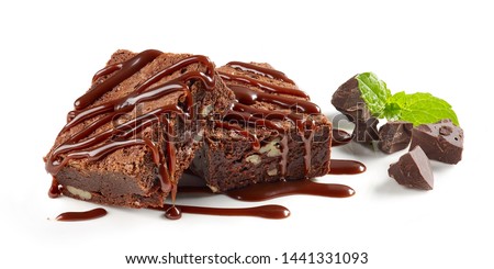 brownie cake pieces with chocolate sauce isolated on white background