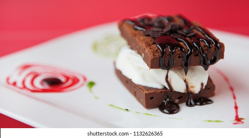 Brownie Sandwich With Chocolate Sauce And Ice Cream.

