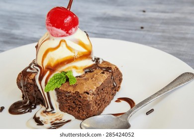 Brownie Sundae With Scoop Of Vanilla Ice Cream And Cherry On Top