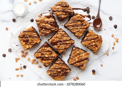 Brownies With Caramel, Peanuts, And A Chocolate Drizzle