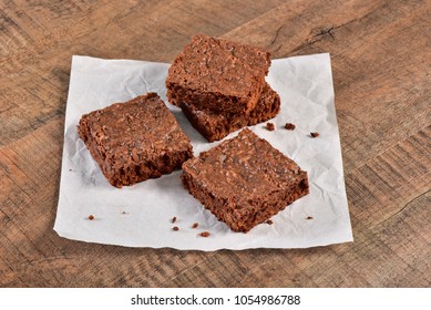 Brownies On Wooden Under Wax Paper