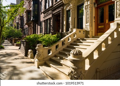 Brownstones with doorsteps and ornament in morning light. Upper West Side Street, Manhattan, New York City - Shutterstock ID 1019513971