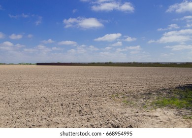 Brownsville, TX - February 18, 2017: Border Fence Stretches On Privately Owned Land, Separating U.S. From Mexico.