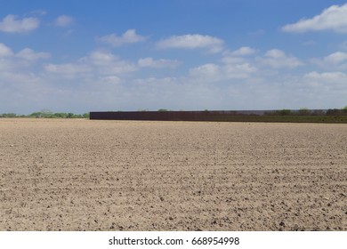 Brownsville, TX - February 18, 2017: Border Fence Stretches On Privately Owned Land, Separating U.S. From Mexico.