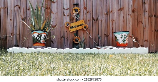 Brownsville TX USA July 10th 2022: A Welcome Sign Between Two Plant Pots Outside In The Backyard.