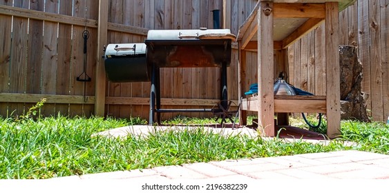 Brownsville TX USA July 10th 2022: An Old Griller With Some Rust And A Wooden Counter Besides It Outside In The Backyard Patio.