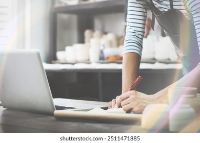 browsing laptop while working in studio - Powered by Shutterstock