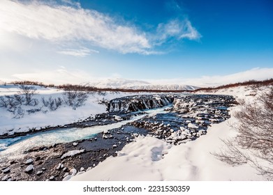 Bruarfoss Waterfall. The 'Iceland’s Bluest Waterfall.' Blue water flows over stones. Winter Iceland. Visit Iceland.
