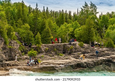 Bruce Peninsula National Park, Canada – June 27, 2022: Colourful Green Waters At Indian Head Cove On Lake Huron In Bruce Peninsula National Park And Clear Blue Water In Ontario Located Near Grotto.