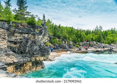 Bruce Peninsula National Park, Canada – June 27, 2022: Colourful Green Waters At Indian Head Cove On Lake Huron In Bruce Peninsula National Park And Clear Blue Water In Ontario Located Near Grotto.