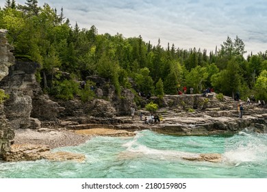 Bruce Peninsula National Park, Canada – June 27, 2022: Colourful Green Waters At Indian Head Cove On Lake Huron In Bruce Peninsula National Park And Clear Blue Water In Ontario Located Near Grotto.