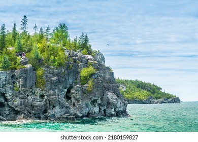 Bruce Peninsula National Park, Canada – June 27, 2022: Colourful Green Waters At Indian Head Cove On Lake Huron In Bruce Peninsula National Park And Clear Blue Water In Ontario Located Near Grotto.