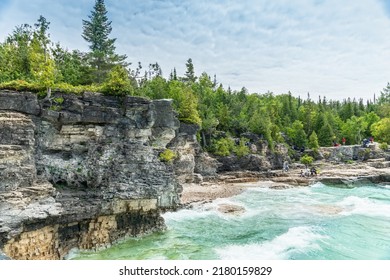 Bruce Peninsula National Park, Canada – June 27, 2022: Indian Head Cove At Tobermory Turquoise Blue Water And Green Pine Forest In Ontario. Summer Day At Bruce Peninsula National Park Near Bruce Trail