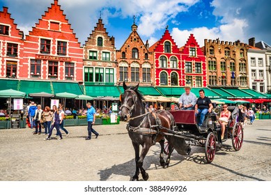 BRUGES, BELGIUM - 7 AUGUST 2014. Horse carriage on Grote Markt square. Belgian city of Bruges (Brugge) is UNESCO world heritage listed for its medieval center.