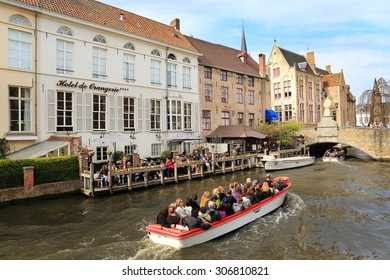 Bruges, Belgium, April 16, 2015. Tourists On A Canal Boat Tour