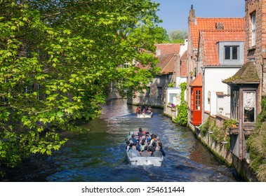 Bruges, Belgium, April 30, 2014. Tourists On A Canal Boat Tour