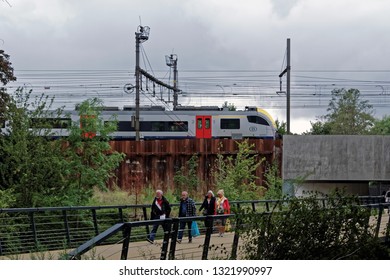 Bruges, Belgium - August 13, 2018: People Walking On A Small Modern Bridge. 