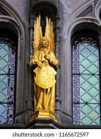 Bruges, Belgium - August 18, 2018: Statue at the Basilica of the Holy Blood in Bruges, of an Angel holding a shield with the Flemish Lion