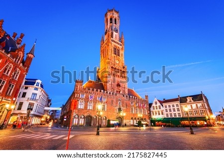 Bruges, Belgium. Blue hour landscape with famous Belfry tower and medieval buildings in Grote Markt, Flanders.