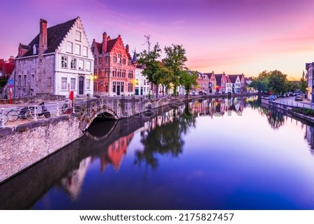 Bruges, Belgium. Blue hour sunrise landscape with water reflection houses on Spiegelrei Canal, famous Flanders landmark.
